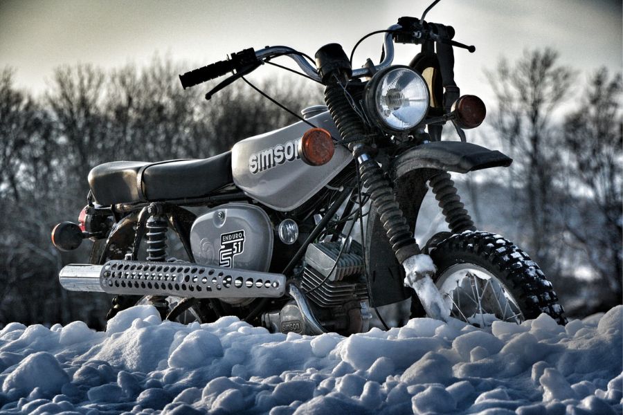 A motorcycle in winter with snow